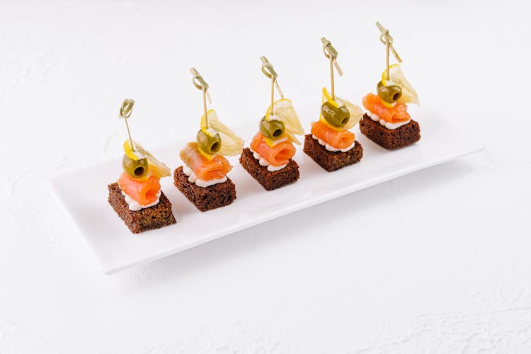 Salmon canapes on toast with olives and lemon