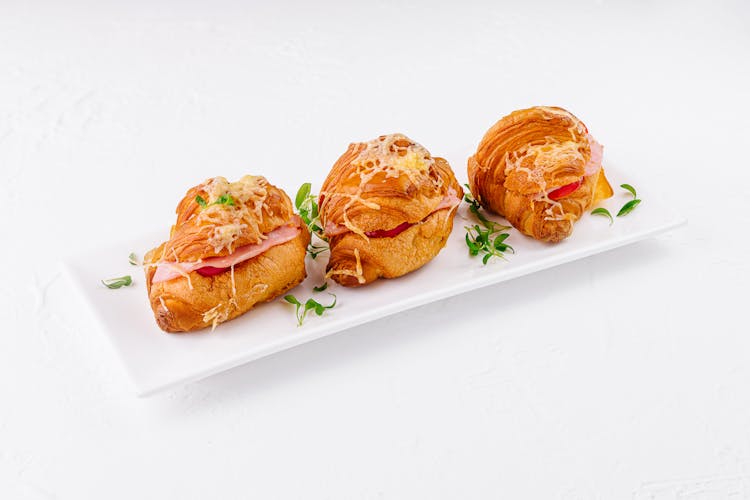 Croissant baked with cheese, cherry tomatoes and prosciutto cotto